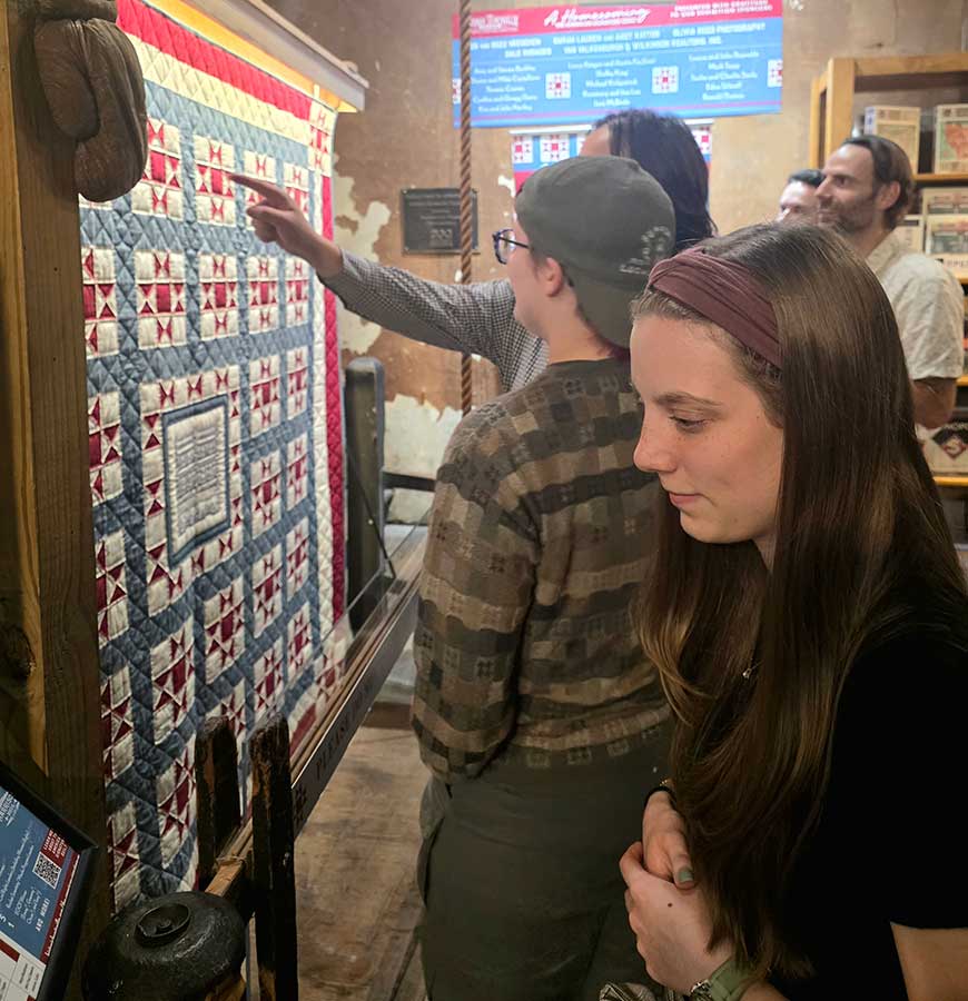 Students paused to study The American Signature Quilt, stitched with more than 170 autographed linen squares—a living tapestry of American stories that bridges art, politics, achievement, and memory.